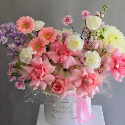 Lovely Pink Flower Box featuring orchids, gerberas, reflexed roses, and a touch of stock in soft pink and pastel tones