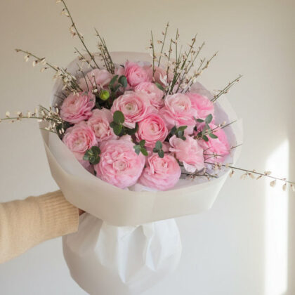 Pink Ranunculus, Genista, eucalyptus bouquet with soft pink flowers and greenery.