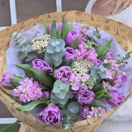 Violet bouquet featuring peony double tulips, stock, and eucalyptus for a lush and elegant look.