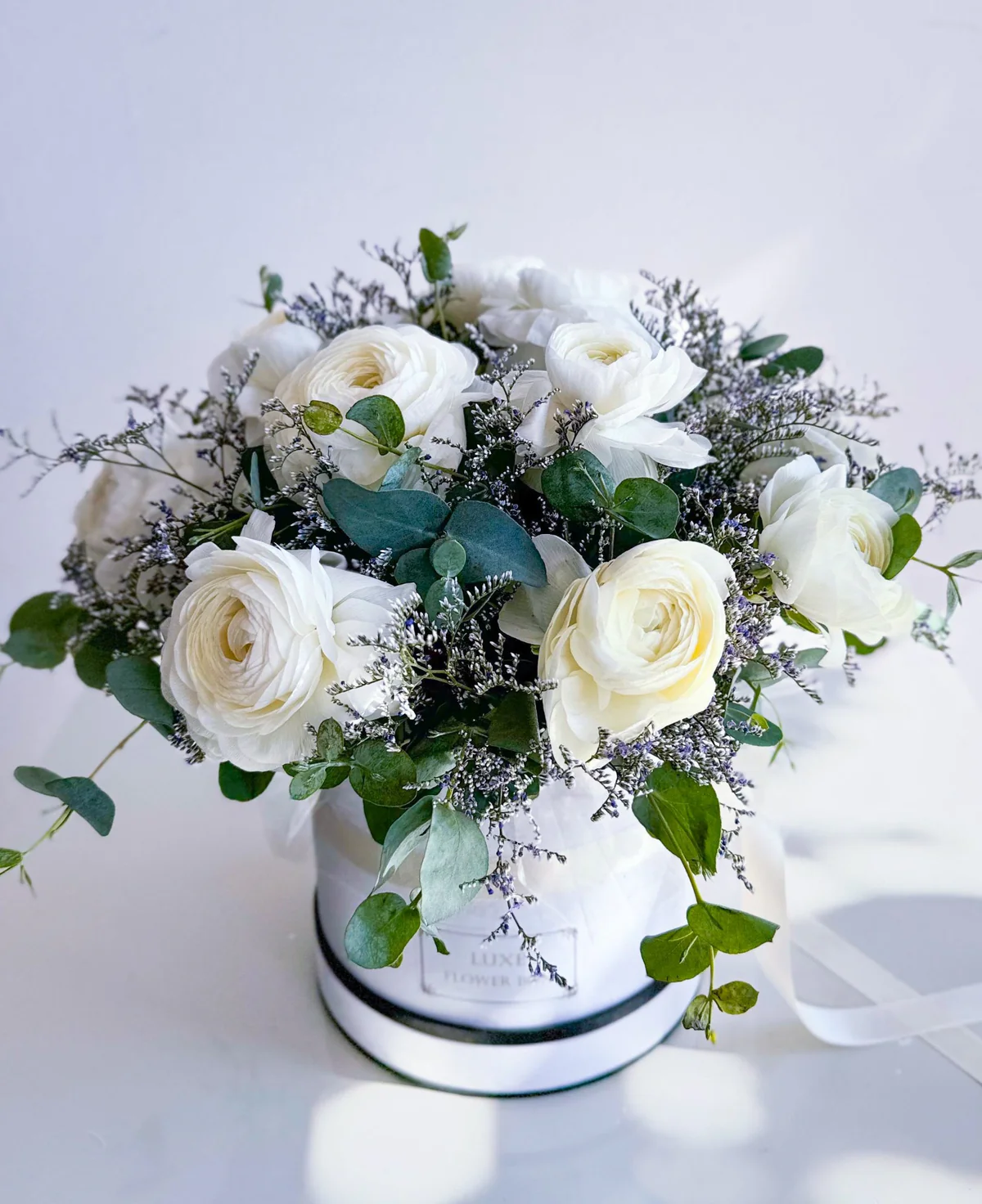 White Ranunculus with Eucalyptus in Round Box